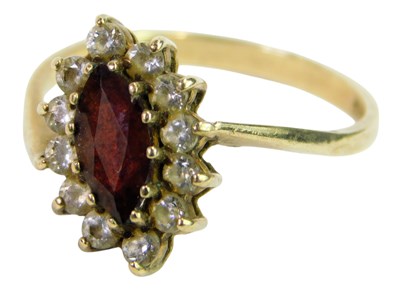 Lot 296 - A 9ct gold ring set with garnet and CZ stones,...