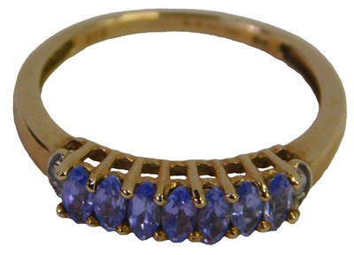 Lot 317 - A 9ct gold and amethyst seven-stone ring, with...
