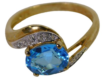 Lot 318 - A 9ct gold topaz and diamond set ring, in a...