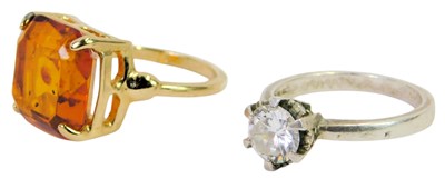 Lot 324 - A CZ solitaire ring, in white metal stamped...
