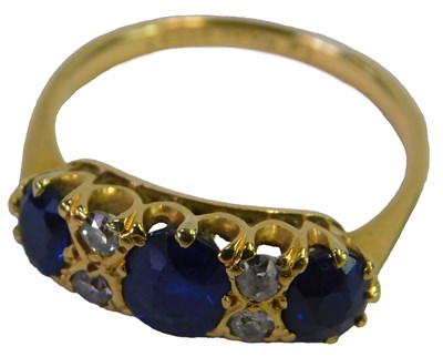Lot 75 - A sapphire and diamond ring, set with three...
