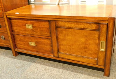 Lot 1002 - A low mahogany side cabinet, in campaign style,...
