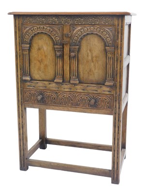 Lot 476 - A 17thC style oak cupboard, with two carved,...