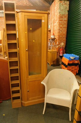 Lot 1029 - A light oak corner cupboard, one glazed door...