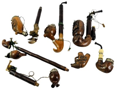 Lot 547 - Four carved German pipe bowls, decorated with...