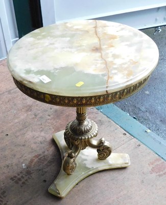 Lot 1067 - A circular onyx-topped occasional table, on a...