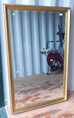 Lot 1072 - A gilt framed bevelled mirror, approx 130cm x...