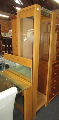 Lot 1057 - A freestanding display unit, with glass...