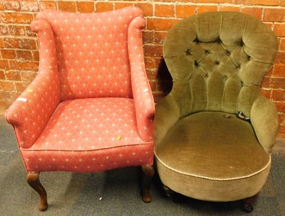 Lot 1053 - A small wingback open armchair, upholstered in...