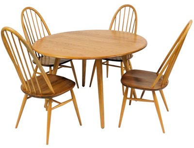 Lot 586 - An Ercol light elm drop leaf dining table, the...