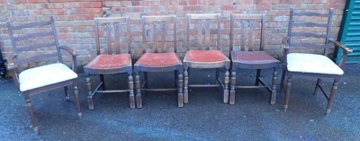 Lot 1094 - A set of four oak dining chairs, each with a...