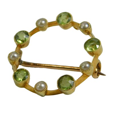 Lot 617 - A peridot and seed pearl brooch, of circular...