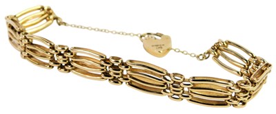 Lot 610 - A 9ct gold four bar gate bracelet, on a...