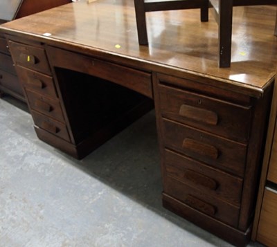 Lot 1503 - A 20thC oak kneehole desk, the top with a...