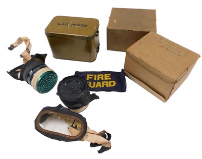 Lot 749 - Two gas masks, one in a metal case, the other...