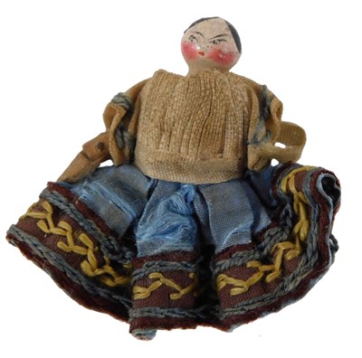 Lot 733 - A miniature painted wooden doll, with tunic...