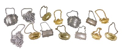 Lot 765 - A quantity of pewter and brass decanter labels.