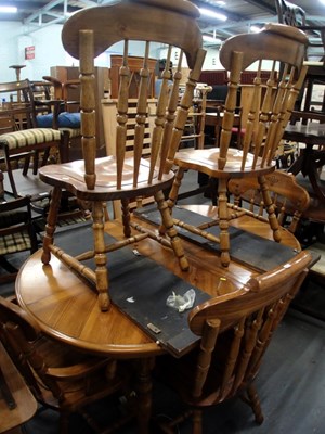 Lot 1520 - An extending oval pine dining table, the top...