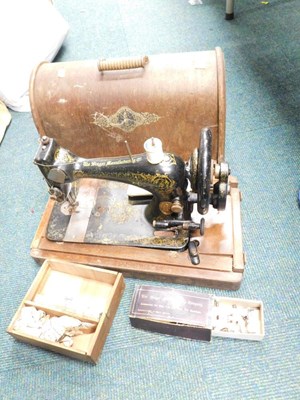 Lot 2052 - A cased Singer hand operated sewing machine.