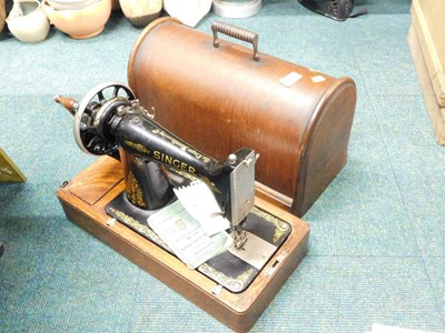 Lot 2084 - An oak cased Singer sewing machine.