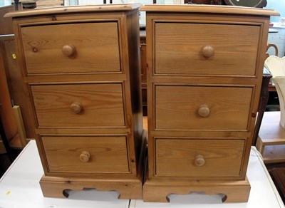 Lot 1544 - A pair of pine bedside cabinets, with three...