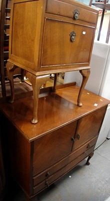 Lot 1592 - A side cabinet, with two cupboards above two...