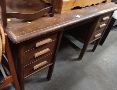 Lot 1598 - A mid century oak office desk, with three...