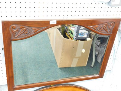 Lot 2183 - A walnut framed wall mirror, with carved...
