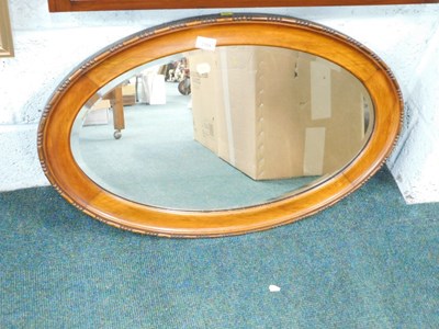 Lot 2184 - An oval wall mirror, with carved egg and dart...