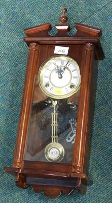 Lot 2185 - A mahogany wall clock, the circular white...