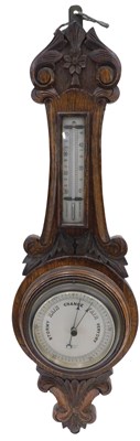 Lot 581 - A late 19thC/early 20thC carved oak aneroid...
