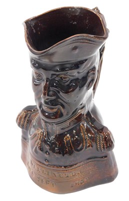 Lot 474 - A 19thC treacle glazed beer Toby, modelled in...