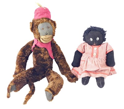 Lot 651 - A vintage brown plush monkey, wearing a fez...