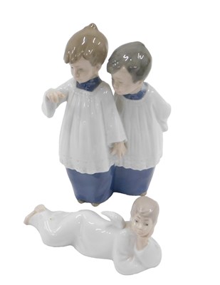 Lot 502 - A Nao figure group of two choir boys and an...