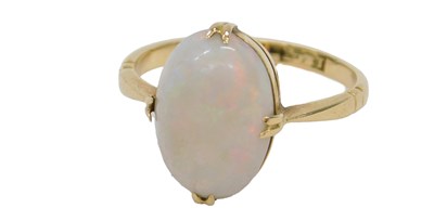 Lot 429 - An opal ring, in oval claw mount, yellow metal,...
