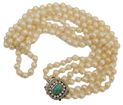Lot 421 - A cultured pearl three strand necklace, on a...