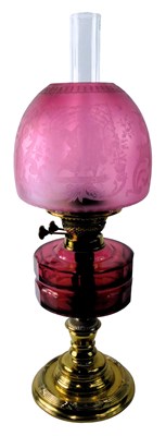 Lot 946 - A Victorian oil lamp, with a frosted cranberry...