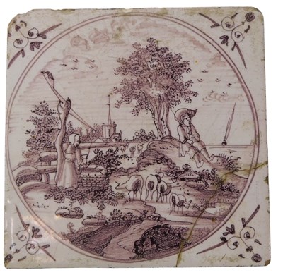 Lot 890 - An 18thC manganese Delft tile, decorated with...