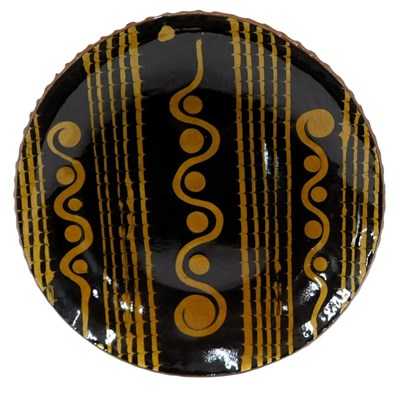 Lot 909 - A Studio pottery slipware charger, maker's...