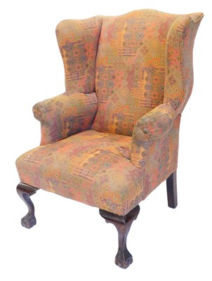 Lot 1076 - A mahogany wingback chair, in mid 18thC style,...