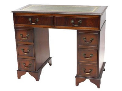 Lot 1100 - A mahogany pedestal desk, the top with a green...