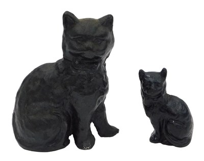 Lot 1014 - A cast iron door stop, modelled as a seated...