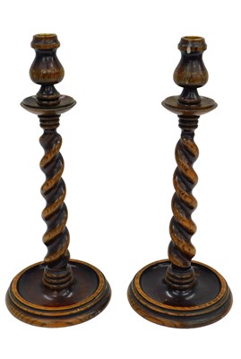 Lot 1040 - A pair of early 20thC oak candlesticks, with...