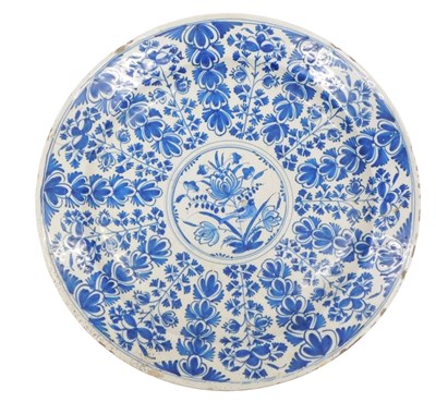 Lot 1053 - An early 19thC Delft charger, decorated...