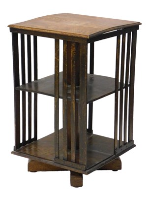 Lot 1117 - An Edwardian oak revolving bookcase, with two...
