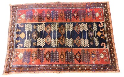Lot 1134 - A Persian rug, with geometric design,...