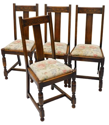 Lot 1195 - A set of four oak dining chairs, each with a...