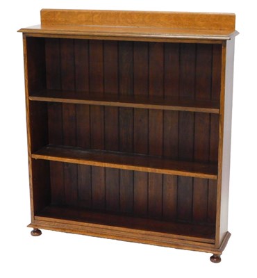 Lot 1197 - An oak open bookcase, with a raised back above...