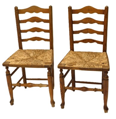 Lot 1201 - A pair of 19thC ash ladderback chairs, each...