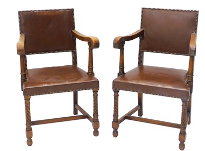 Lot 1163 - A pair of oak open armchairs, each with a...